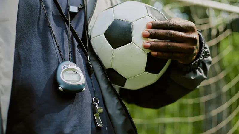Referee holding soccer ball
